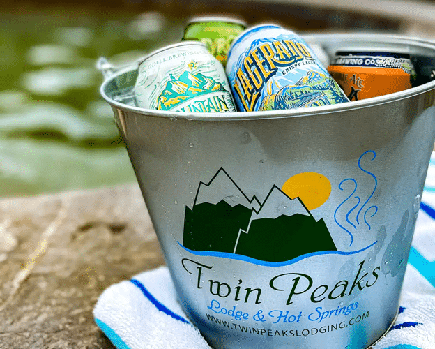 Metal bucket of canned drinks labeled Twin Peaks Lodge.