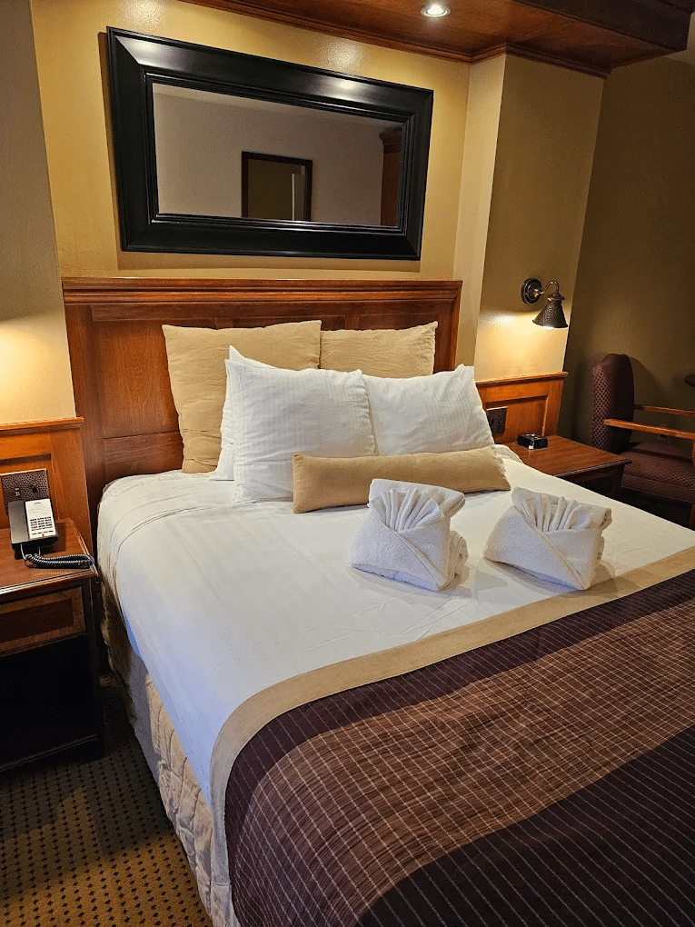 A beautiful room displaying mirror right above the bed