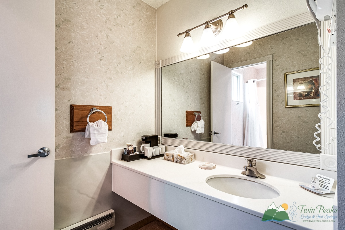 Bright hotel bathroom with vanity and mirror